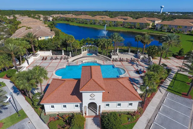 an aerial view of house with yard swimming pool and outdoor seating