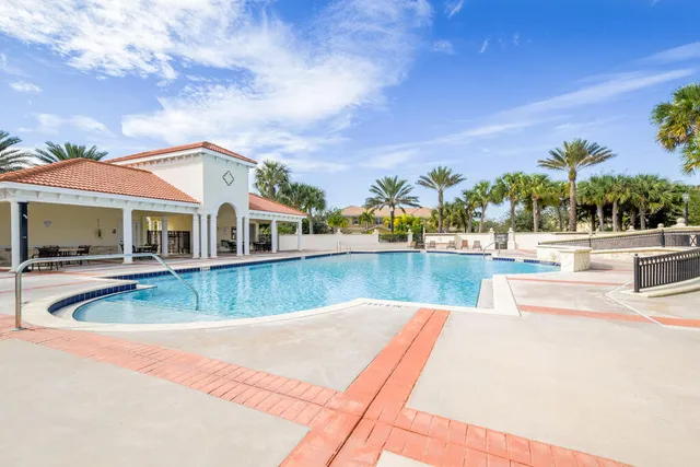 swimming pool view with plants and large trees