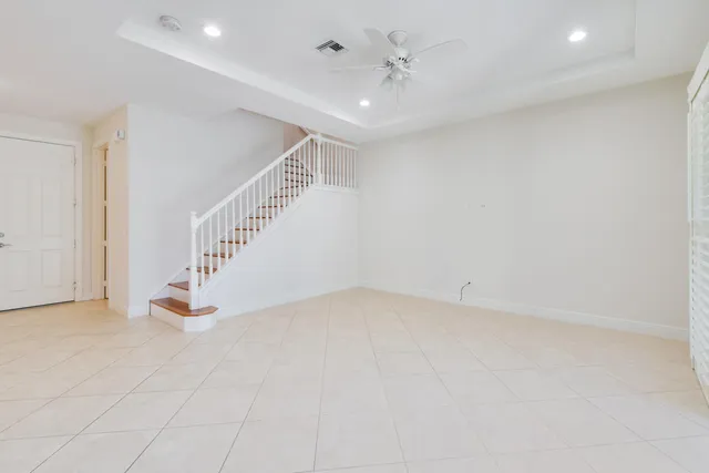 a view of an empty room with stairs