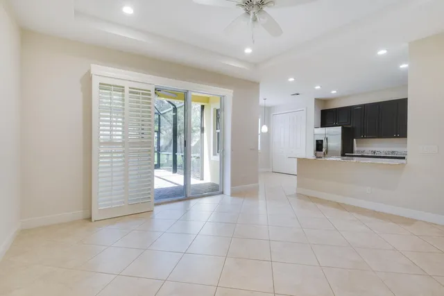 a view of an empty room with a kitchen