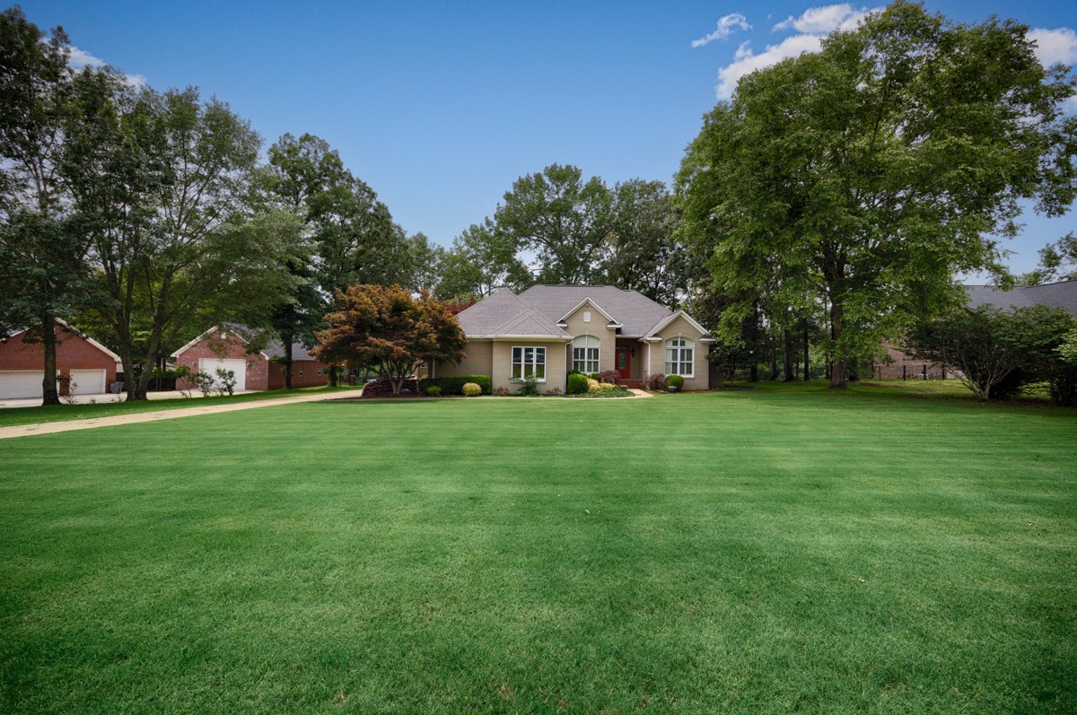 332 Riverfront Road Rogersville, AL 35652 - Photo 31 of 52 a front view of a house with garden and tree