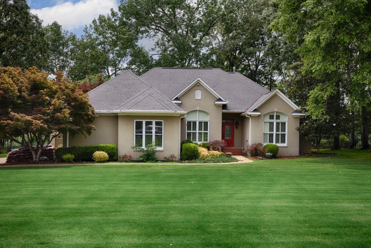 332 Riverfront Road Rogersville, AL 35652 - Photo 32 of 52 a front view of a house with garden and trees