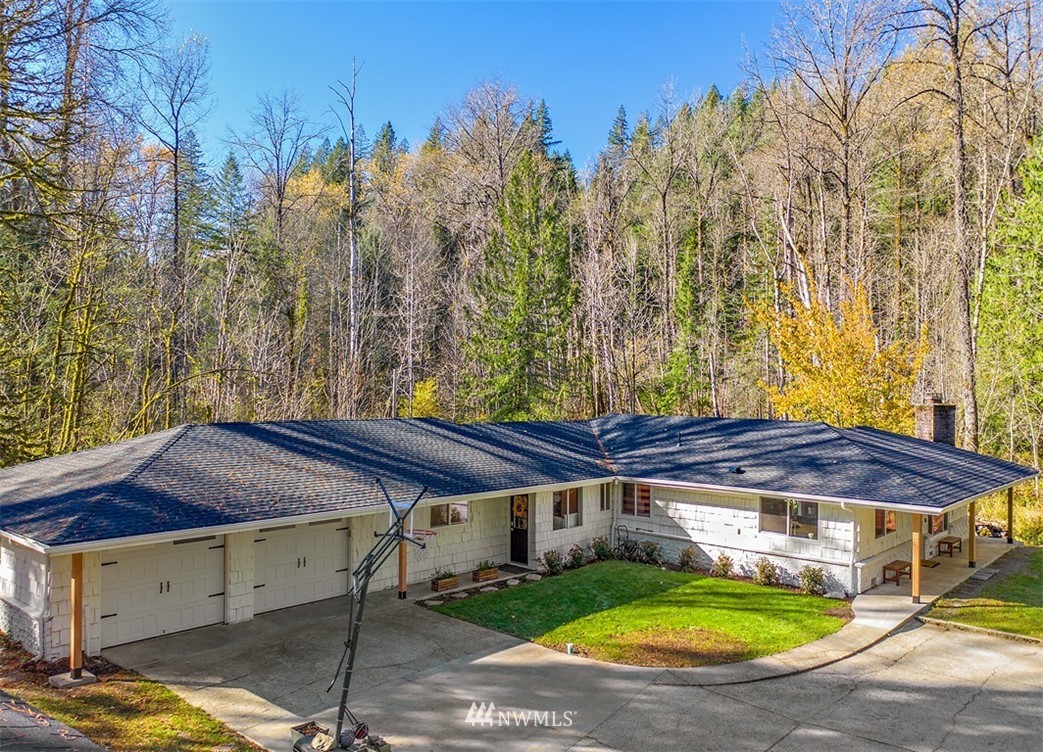 a view of a patio with a table and chairs under an umbrella