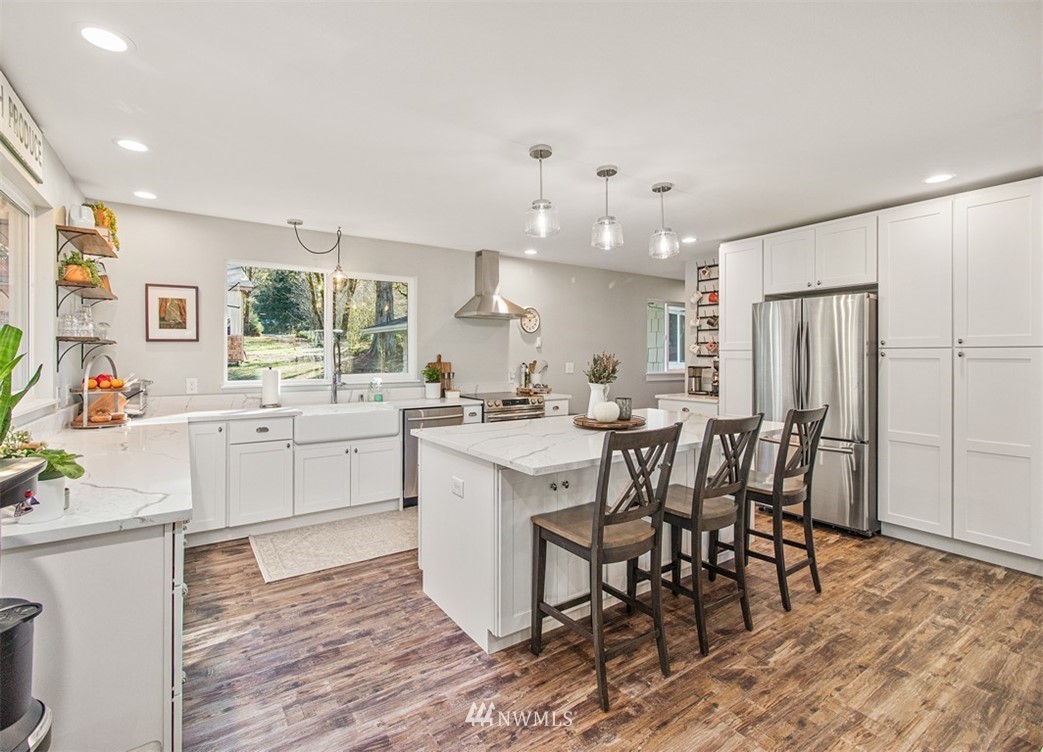 46020 Southeast Edgewick Road North Bend, WA 98045 - Photo 2 of 24 a kitchen with white cabinets and chairs