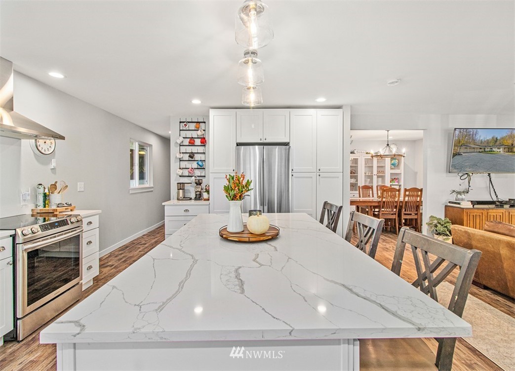 46020 Southeast Edgewick Road North Bend, WA 98045 - Photo 5 of 24 a view of a dining room with furniture a chandelier and wooden floor