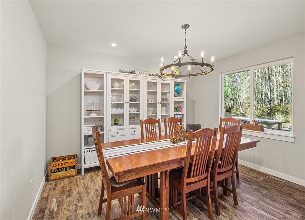 46020 Southeast Edgewick Road North Bend, WA 98045 - Photo 8 of 24 a dining room with furniture a chandelier and wooden floor