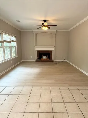 a view of an empty room with a fireplace and a window