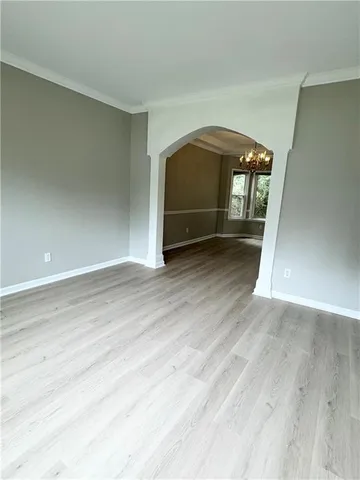 a view of a room with wooden floor