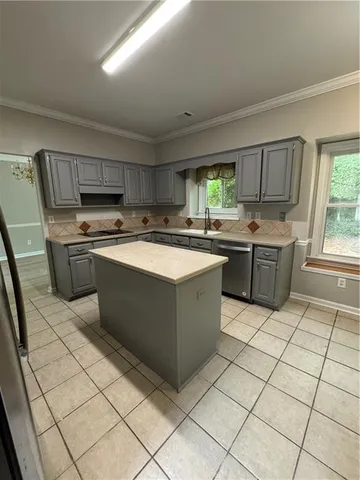 a kitchen with a stove a sink and a refrigerator