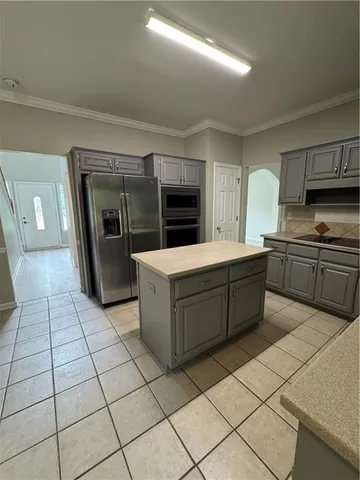 a kitchen with stainless steel appliances granite countertop a sink and cabinets