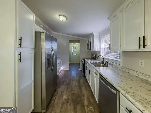 a kitchen with stainless steel appliances granite countertop lots of counter top space and cabinets