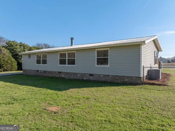 a view of a house with wooden floor and a yard