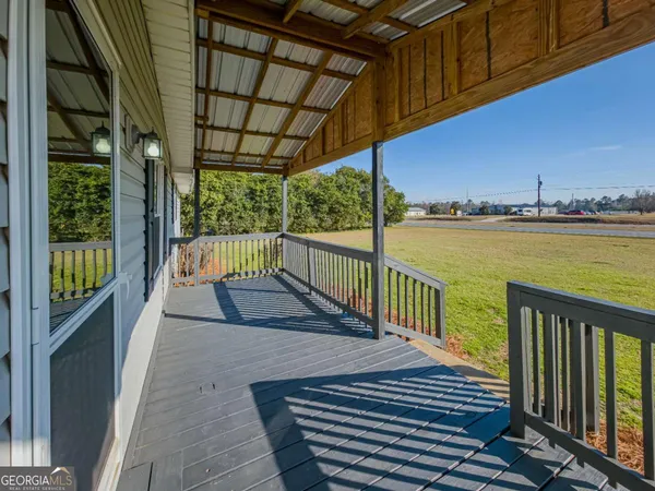 a view of a balcony with lake view and wooden floor