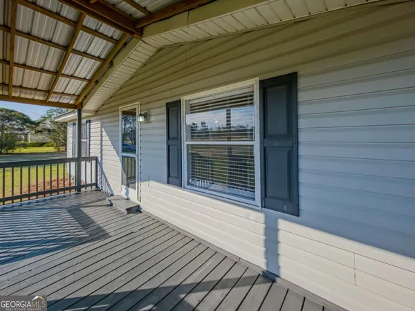 a view of a house with wooden deck