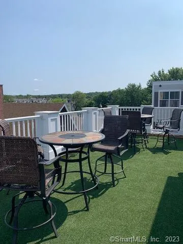 a view of a patio with table and chairs