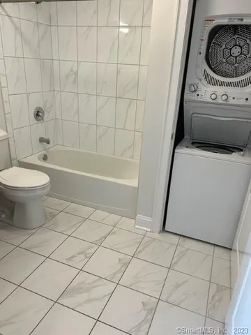 a bathroom with a toilet a sink a vanity and bathtub