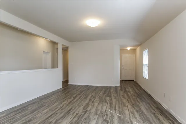 a view of hallway with wooden floor