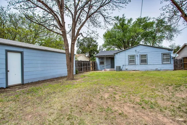 a front view of house with yard and trees