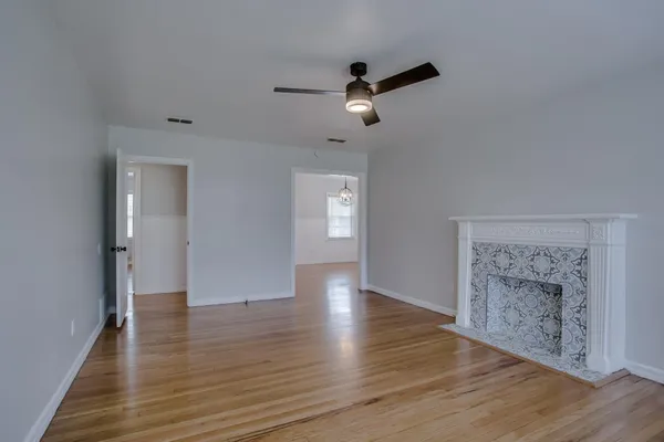a view of an empty room with wooden floor