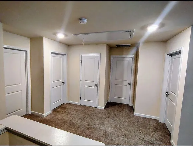 a view of a livingroom with wooden cabinets