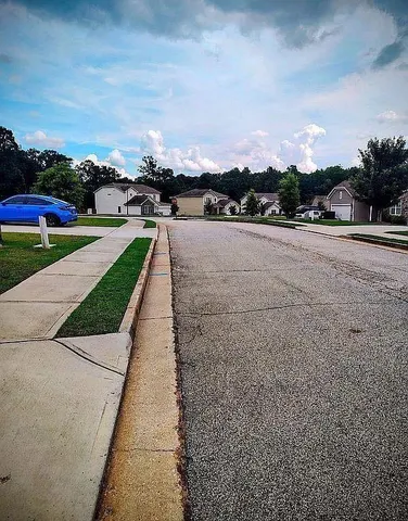 a view of a street with a yard