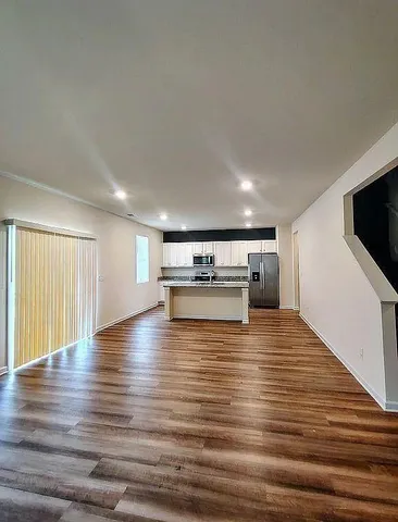 a view of kitchen and kitchen with microwave