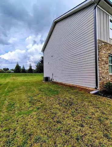 a view of a backyard with plants and a garden