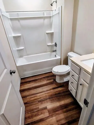 a bathroom with a toilet and a bathtub