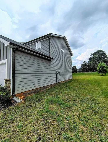 a backyard of a house with lots of green space