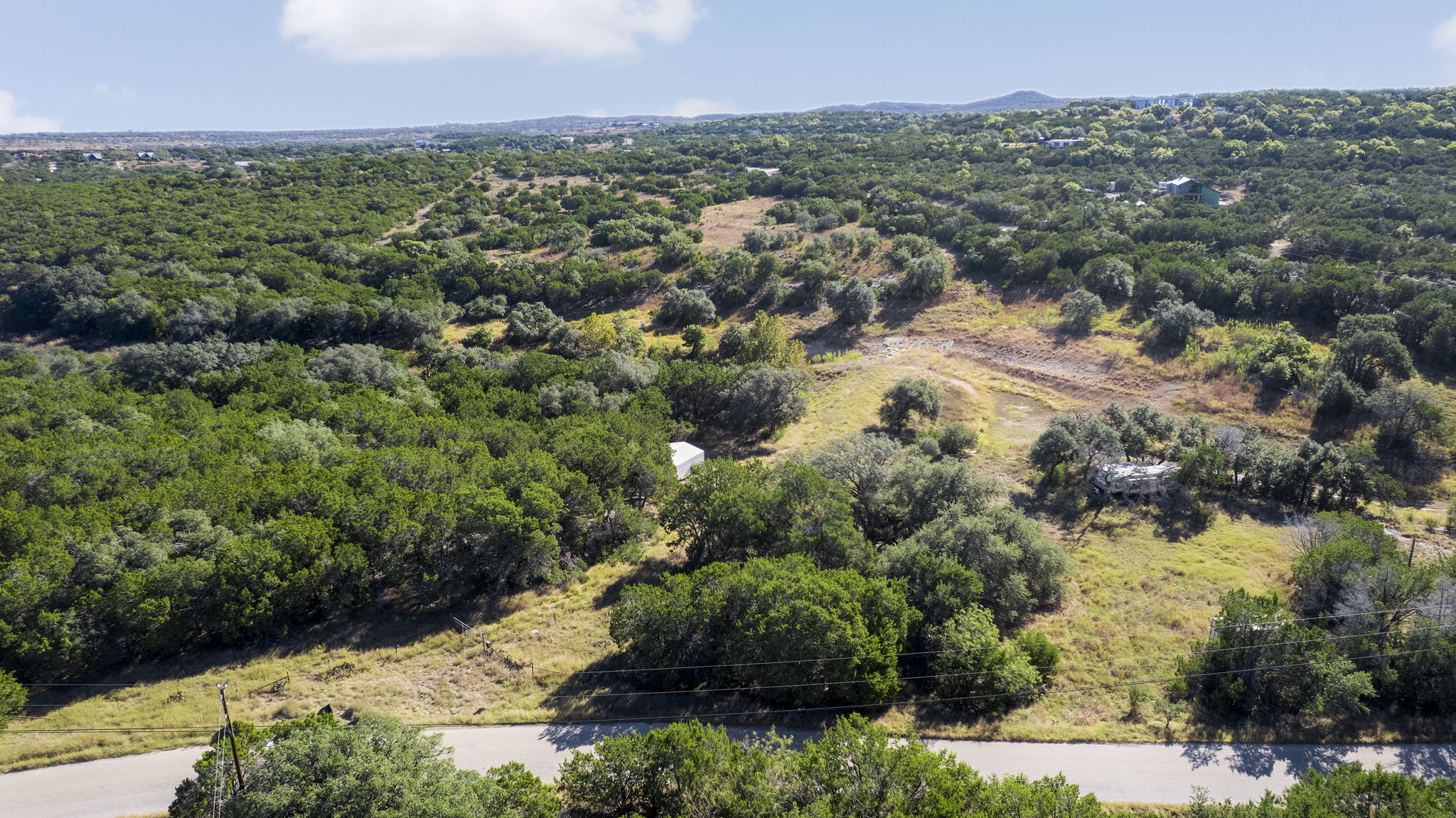 2021 Stagecoach Ranch Road Dripping Springs, TX 78620 - Photo 24 of 35 an aerial view of residential house with outdoor space and trees all around