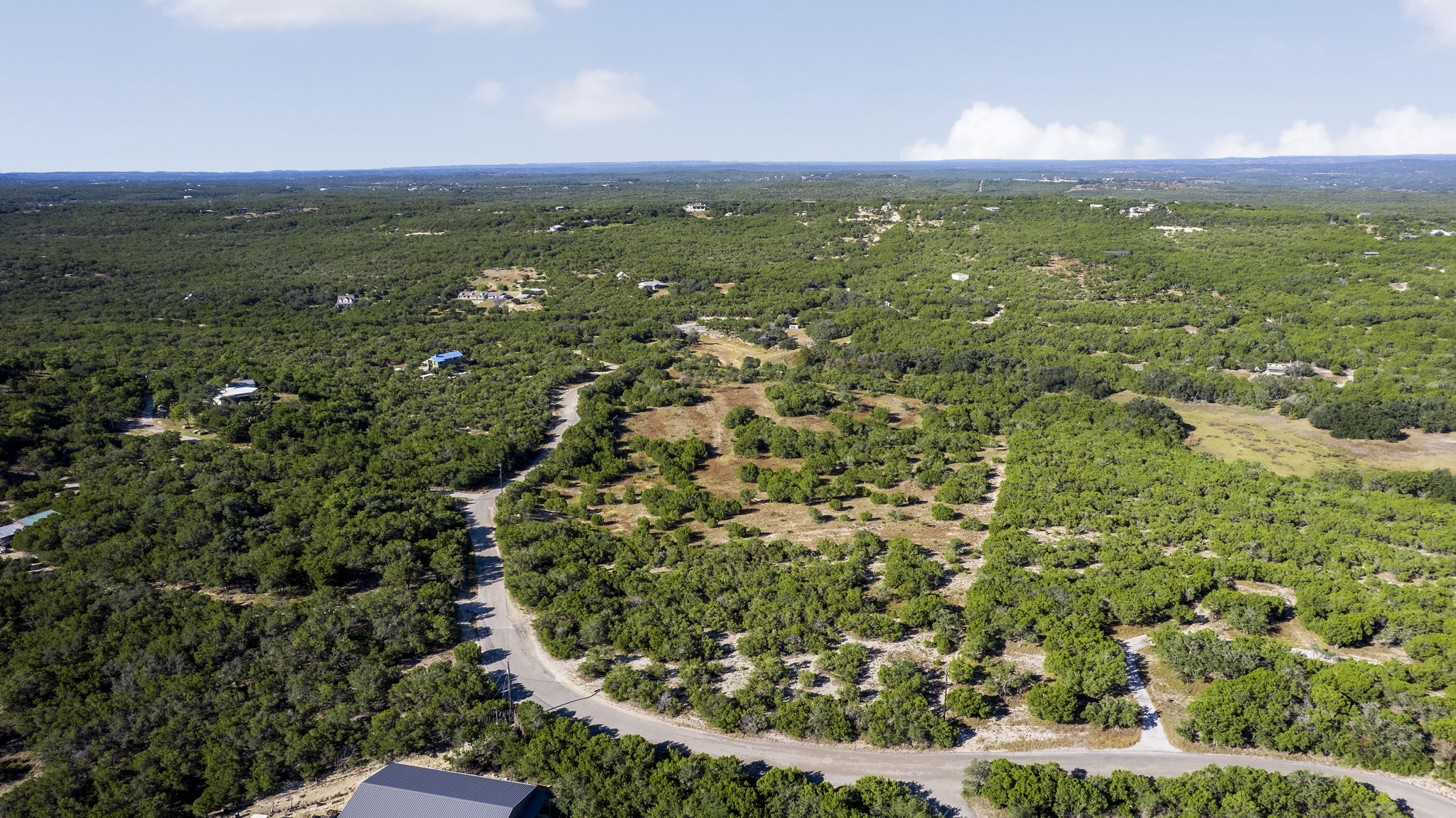 2021 Stagecoach Ranch Road Dripping Springs, TX 78620 - Photo 28 of 35 a view of a city with lush green forest