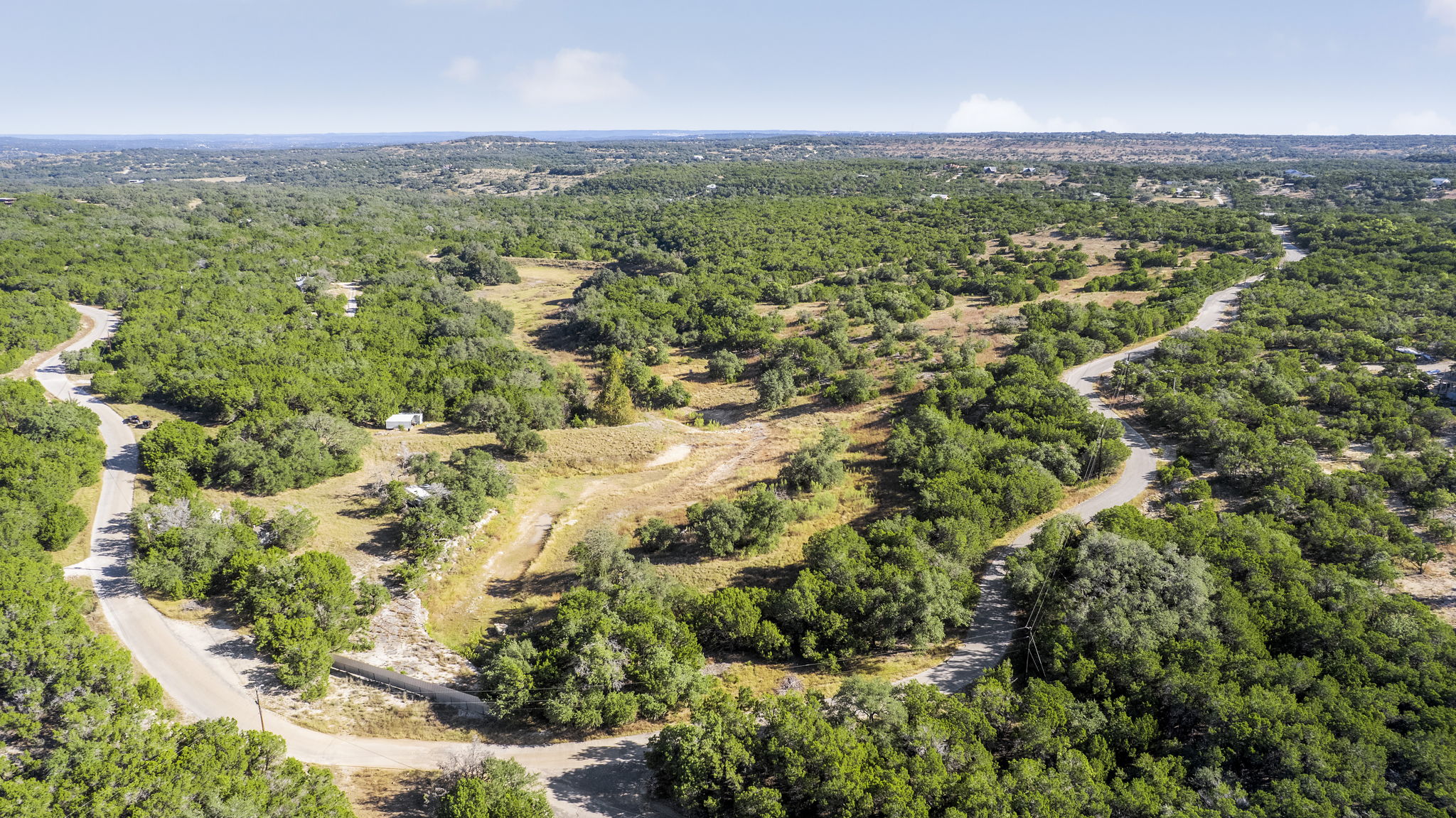 2021 Stagecoach Ranch Road Dripping Springs, TX 78620 - Photo 33 of 35 an aerial view of residential houses with outdoor space and trees