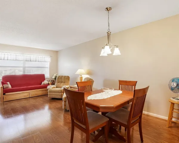 a living room with furniture a chandelier and a window