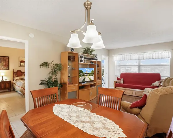 a living room with furniture a couch and a chandelier