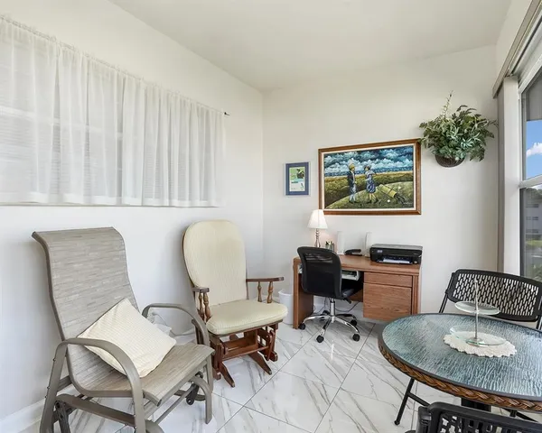 a view of a workspace with furniture and a couch