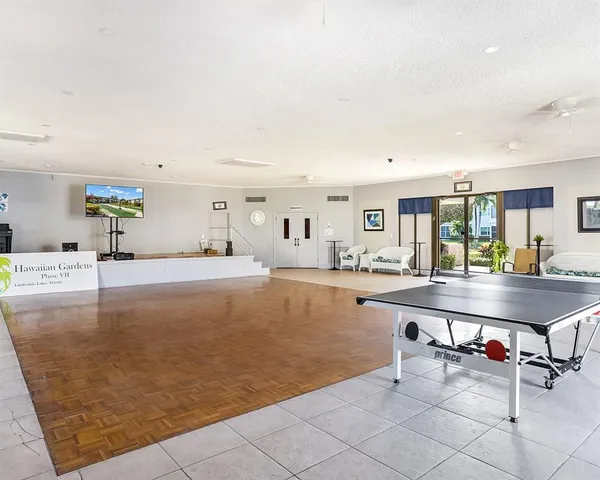 a view of a kitchen with kitchen island and living room in it