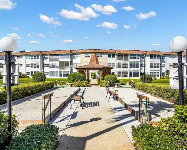 a view of a patio with a dining table and chairs with a swimming pool