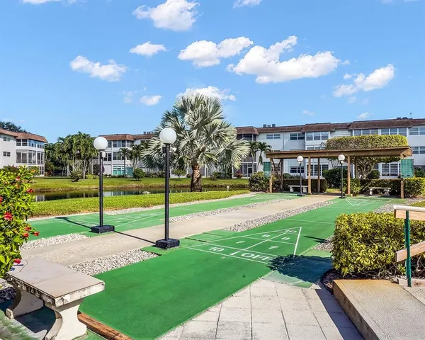 a view of a big house with a big yard and potted plants