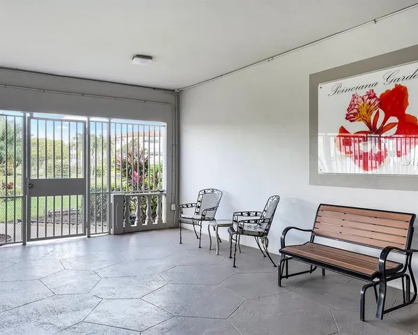 a living room with furniture and a floor to ceiling window