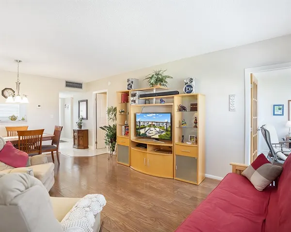 a living room with furniture and a kitchen view