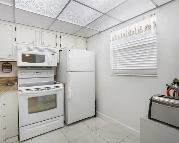 a kitchen with refrigerator a stove a washer and dryer