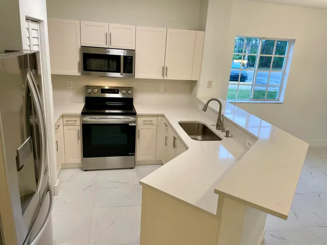 an empty room with a kitchen and a sink