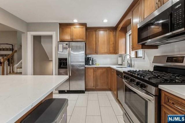 23 Asmus Road Closter, NJ 07624 - Photo 10 of 38 a kitchen with stainless steel appliances granite countertop a stove a sink and a refrigerator