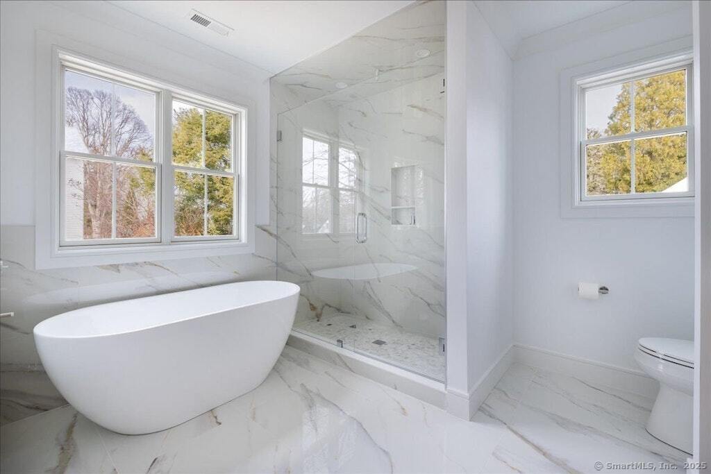 210 Pansy Road Fairfield, CT 06824 - Photo 1 of 14 a bathroom with a bathtub and window