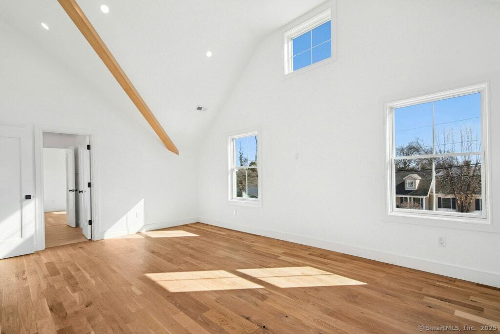 210 Pansy Road Fairfield, CT 06824 - Photo 2 of 14 a view of an empty room with wooden floor and a window