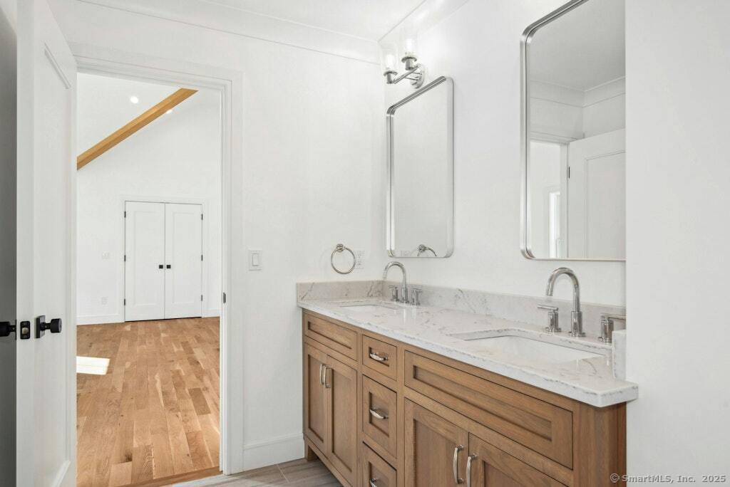 210 Pansy Road Fairfield, CT 06824 - Photo 3 of 14 a bathroom with double sink and a mirror