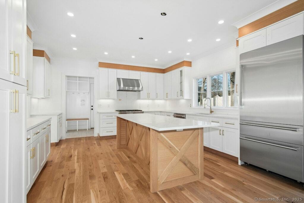 210 Pansy Road Fairfield, CT 06824 - Photo 9 of 14 a kitchen with white cabinets appliances and sink
