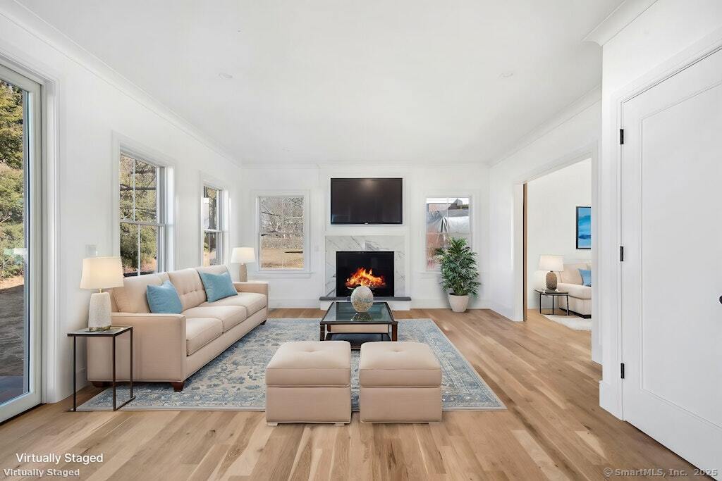210 Pansy Road Fairfield, CT 06824 - Photo 12 of 14 a living room with furniture and a fireplace