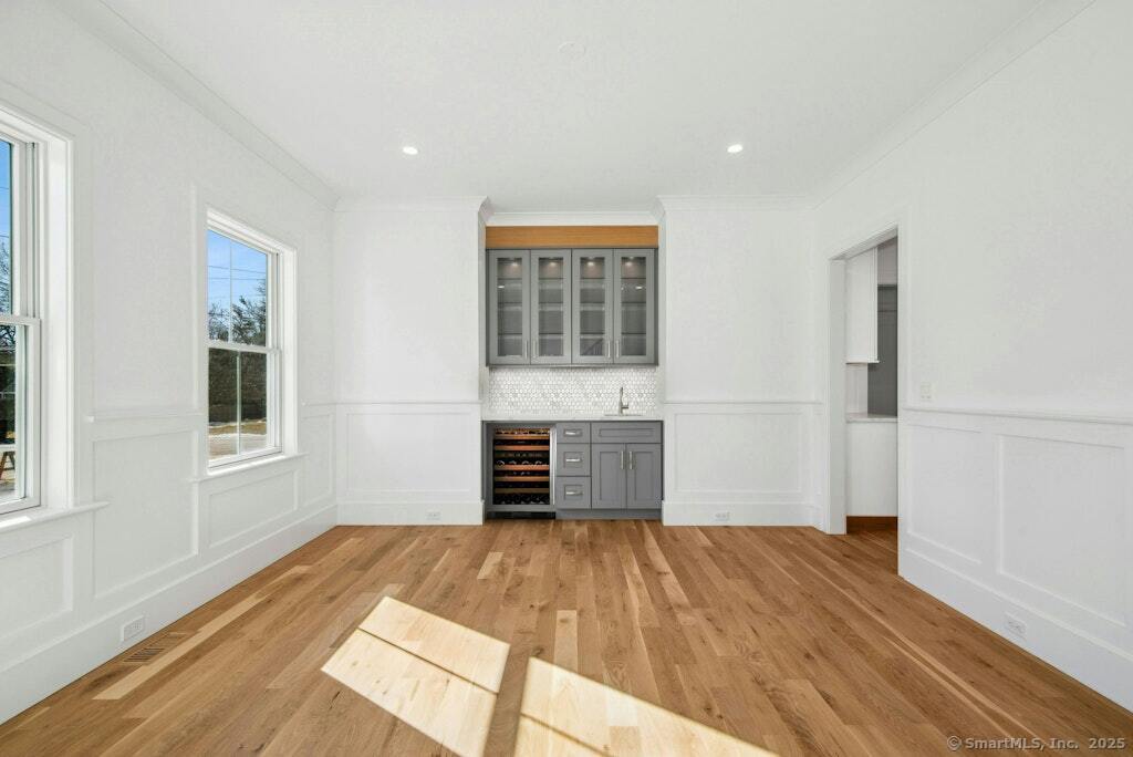 210 Pansy Road Fairfield, CT 06824 - Photo 14 of 14 a view of empty room with wooden floor and windows