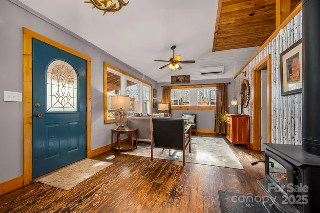 a bedroom with bed and wooden floor